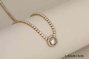 Detailed close-up of a gold-plated tennis necklace with a 42cm+5cm adjustable chain