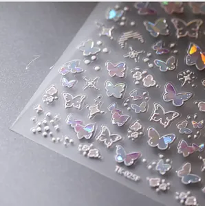 Detail of TK-025 laser nail stickers featuring iridescent butterfly and star patterns
