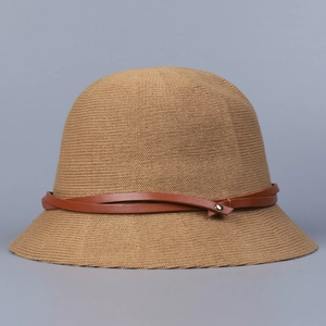Detail of khaki breathable knitted bucket hat featuring a brown leather strap and gold buckle