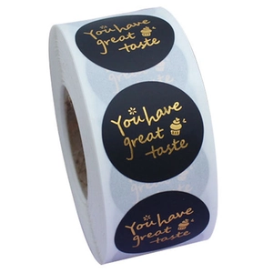 Macro view of matte black round stickers with gold foil You have great taste text