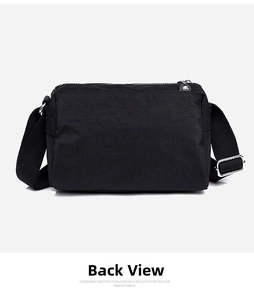 Back view of a multi-pocket black nylon crossbody bag with adjustable wide shoulder strap