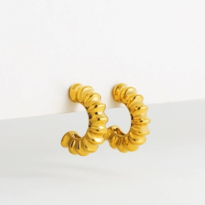 Close-up of 18K gold plated hoop earrings featuring a unique textured croissant design
