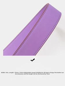 Macro view of purple leather adjustable bag strap with fine stitching and gold buckle
