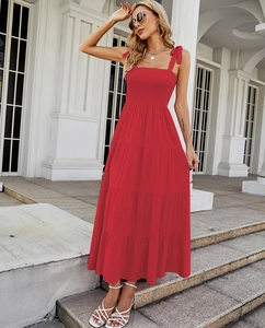 Detail of red tiered maxi dress featuring ruffle chest design and bow tie shoulder straps