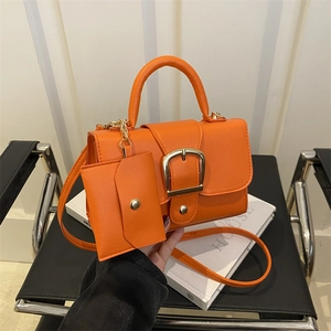 Vibrant orange candy-colored PU leather handbag set with gold buckle and matching small pouch