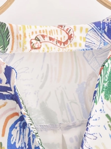 Detailed close-up of V-neck collar stitching and colorful graffiti print on women shirt
