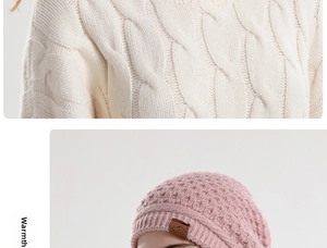 Close-up of white cable knit sweater and pink knit beanie with sport leather patch