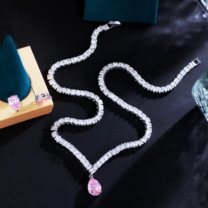 Close-up of pink pear-cut gemstone jewelry set with necklace and stud earrings