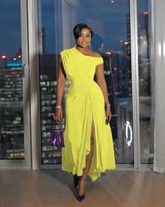 Detail of yellow one-shoulder dress showing waist ruching and side high slit design