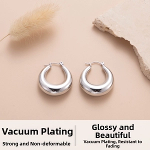 Close-up of teardrop hoop earrings with high-polish silver finish and water drop design