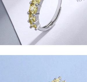 Macro detail of silver band ring featuring five square-cut yellow zircon stones