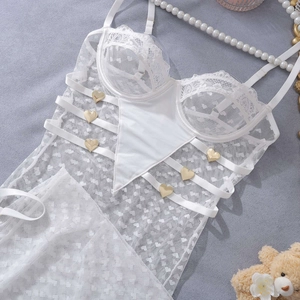 Detailed view of white heart lace lingerie with satin straps and golden heart buckles