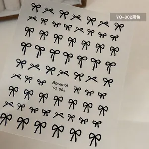 Detail view of YO-002 self-adhesive nail art stickers with black bowknot patterns