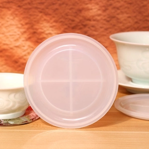 Detail of round translucent silicone coaster mold with cross ribbing for DIY crafts