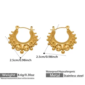 Detailed view of gold stainless steel hoop earrings with textured bohemian relief patterns