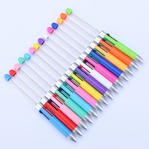 Row of 14 colorful retractable telescopic beadable pointer pens on a white background