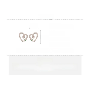 Detail view of snake heart stud earrings featuring white and green cubic zirconia stones