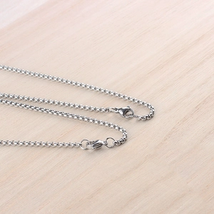 Detail of silver lobster clasp and box chain links on a stainless steel necklace