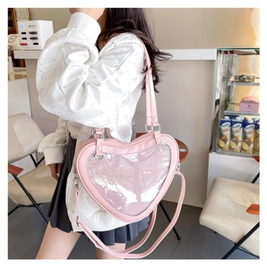 Pink heart-shaped ita bag for JK uniform showing transparent window and faux leather texture