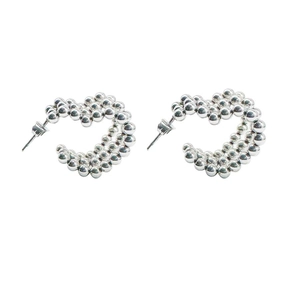 Detailed view of silver C-shaped hoop earrings featuring a beaded heart-shaped design
