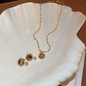 Vintage style jewelry set with cat eye stone pendant necklace and matching stud earrings