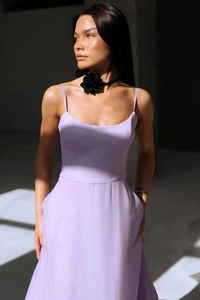 Detail of lavender spaghetti strap dress paired with a black rose choker in sunlight