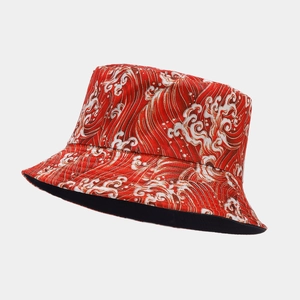 Close-up of red bucket hat featuring Japanese wave patterns and twill cotton texture
