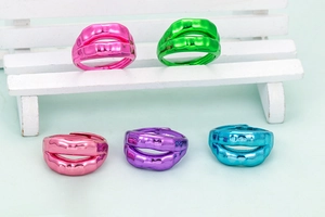 Colorful lip-shaped open rings in five vibrant finishes on a minimalist background