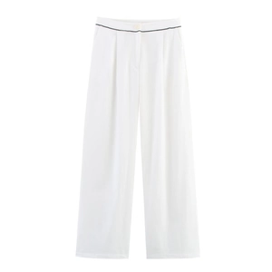 Detail of high-waist wide-leg white trousers with black piping and button detail