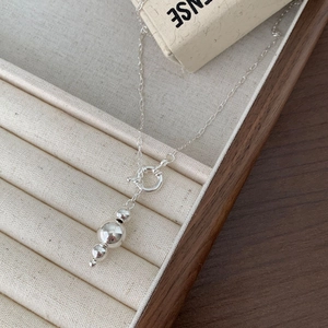 Minimalist 925 sterling silver bead necklace displayed on a beige velvet jewelry tray