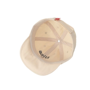 Inside view of beige cotton baby baseball cap featuring Nice embroidery under the brim