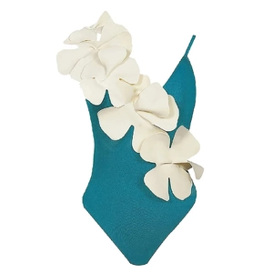 Detail of teal one-piece swimsuit featuring 3D white floral appliqués on shoulder