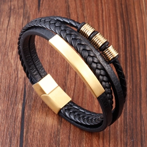 Close-up of multilayer black leather braid bracelet with golden magnetic metal clasp