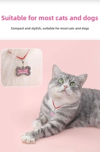 Detail of pink bone-shaped pet ID tag with sparkling white rhinestones and photo frame