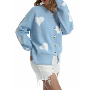 Detail view of light blue cardigan featuring white heart jacquard and amber buttons