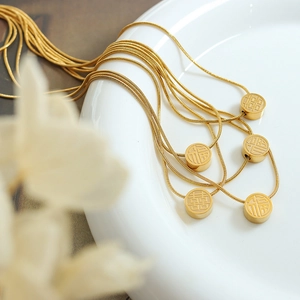 18K gold plated titanium necklace with sliding Fu and Xi character pendants on a chain