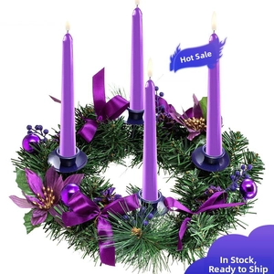 Christmas advent wreath with green pine needles, purple candles and silk ribbon bows