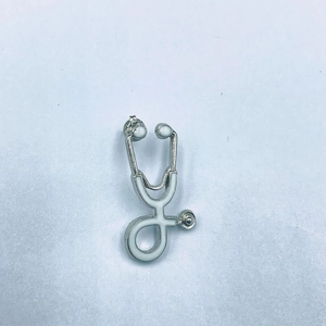 Medical themed stethoscope brooch pin with silver metal frame and white enamel filling