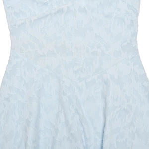Macro shot of light blue jacquard fabric texture with elegant V-seam and embossed patterns