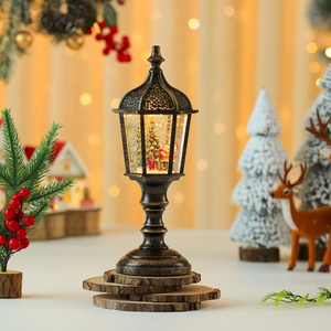 Close-up of a vintage bronze Christmas snow globe lamp featuring Santa and a tree