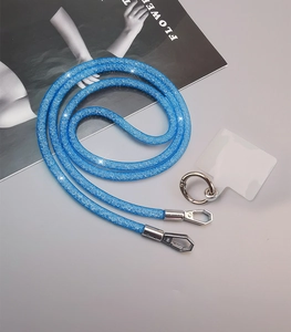 Detail of blue glitter mesh crossbody phone strap with durable metal clasp and clear pad
