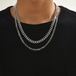 Detail of silver double-layered stainless steel twist curb chain necklaces on a model