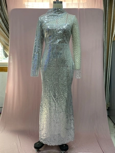 Close-up of silver sequin evening gown featuring sheer mesh and high mock neck detail