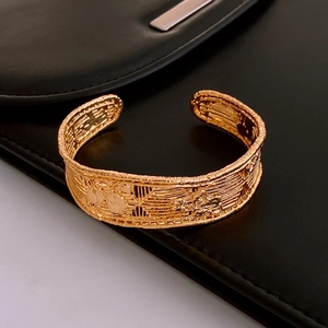 Detailed macro view of the gold-plated vintage mesh texture on this open cuff bracelet