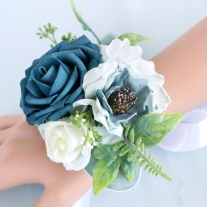 Navy blue and white silk rose wedding wrist corsage with ribbons and green leaves