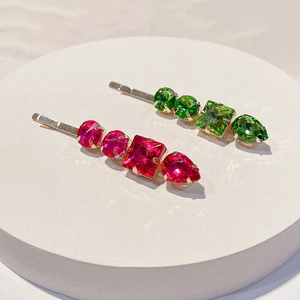 Detailed view of colorful rhinestones on elegant metal hair clips with geometric gems