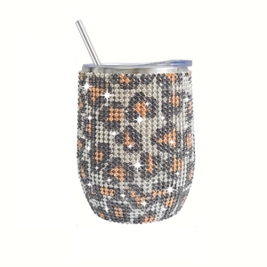 Close-up of leopard pattern rhinestone 12oz stainless steel tumbler with straw