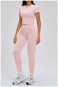 Close-up of pink yoga set fabric texture and stitching on crop top and high waist leggings
