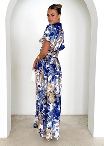 Detail of floral ruffle neck dress with blue and gold botanical prints and waist belt