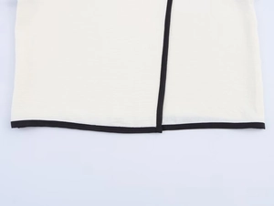 Close-up detail of contrast color trimming and high quality stitching on crepe top